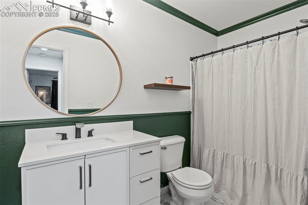 Image 32 of 39: Full bathroom featuring vanity and ornamental molding