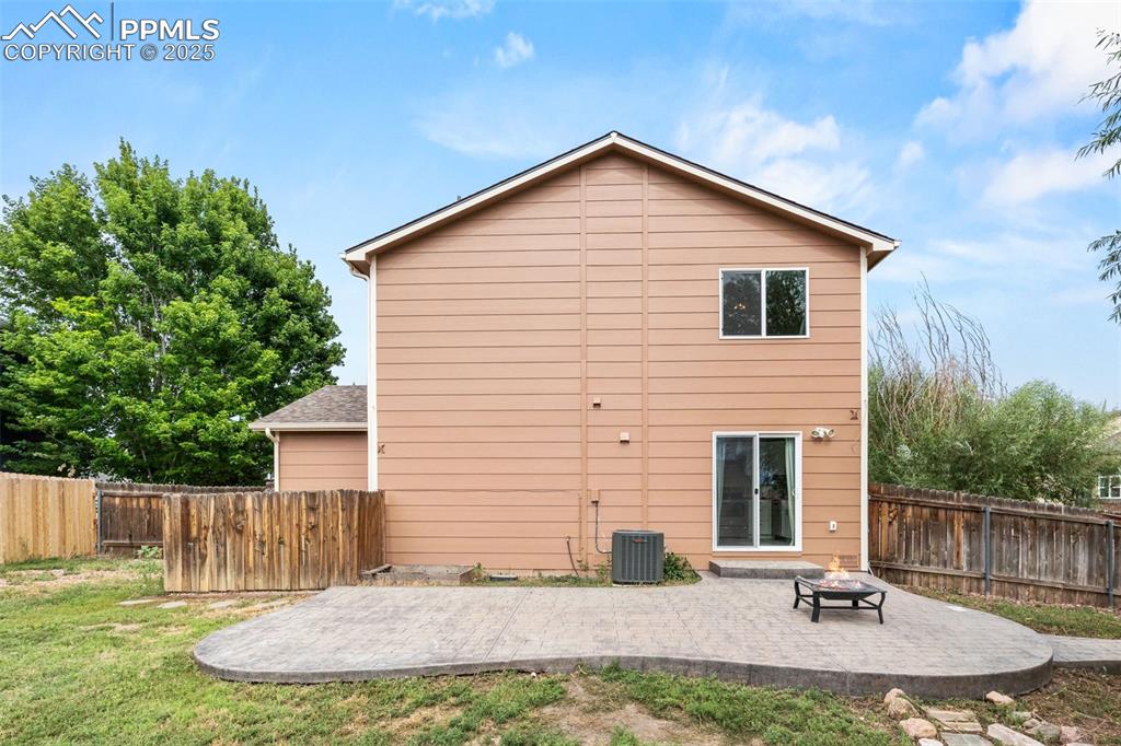 Image 38 of 39: Rear view of property with a patio area, a fenced backyard, and a fire pit
