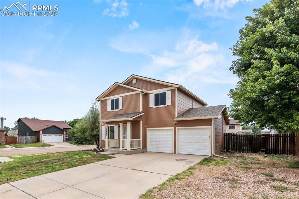 Image 4 of 39: Traditional-style home featuring driveway and a garage