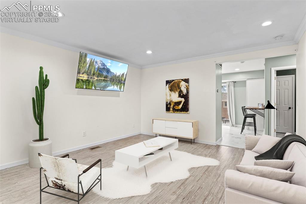 Image 6 of 39: Living room with plenty of natural light, light wood-style flooring, recess