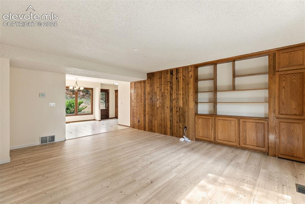 Image 20 of 49: Main level family room with built-ins.