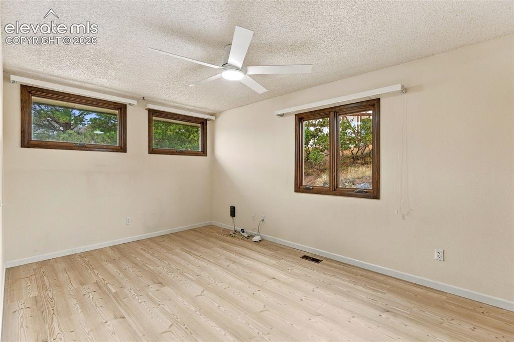 Image 25 of 49: Upper level bedroom.