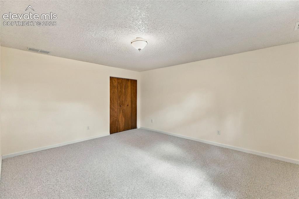 Image 34 of 49: Basement bedroom.
