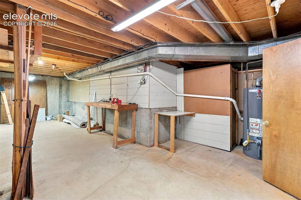 Image 36 of 49: Basement shop/storage area.