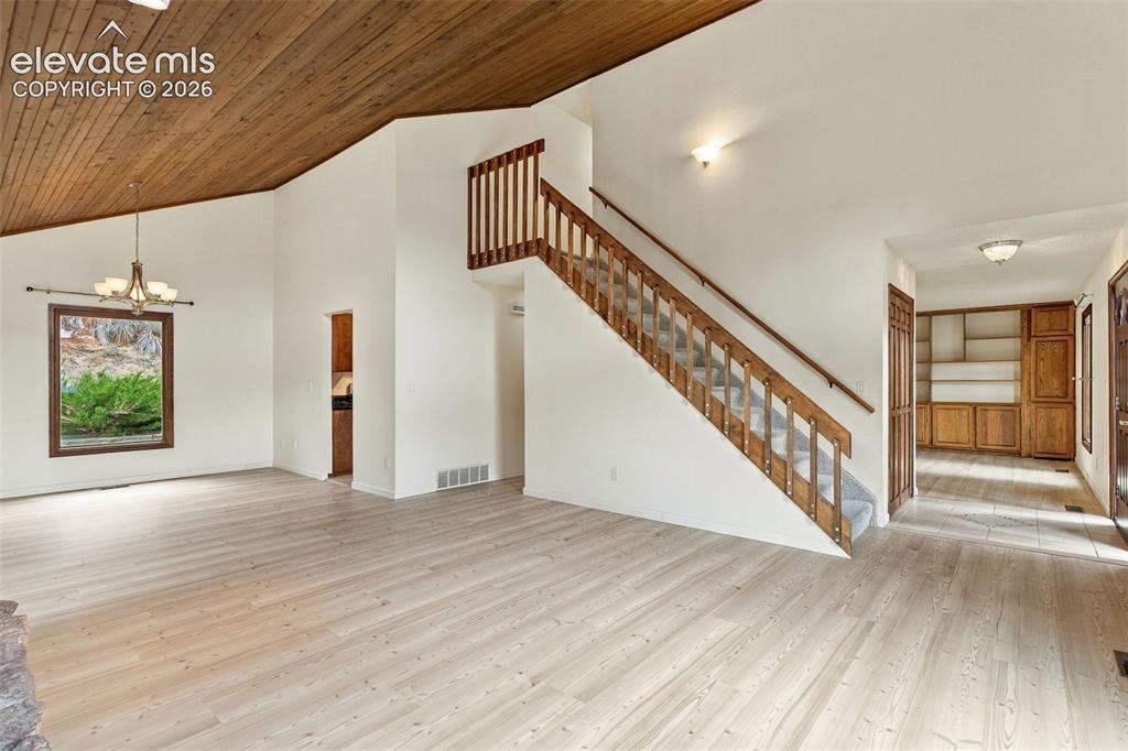 Image 8 of 49: Living and formal dining areas have vaulted ceilings.