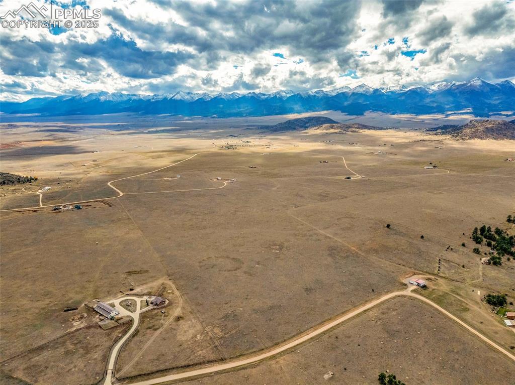 Image 12 of 14: Aerial view of sparsely populated area featuring a desert landscape and a m