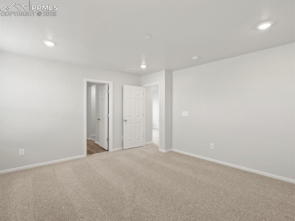 Image 15 of 25: Spare room with carpet flooring and recessed lighting