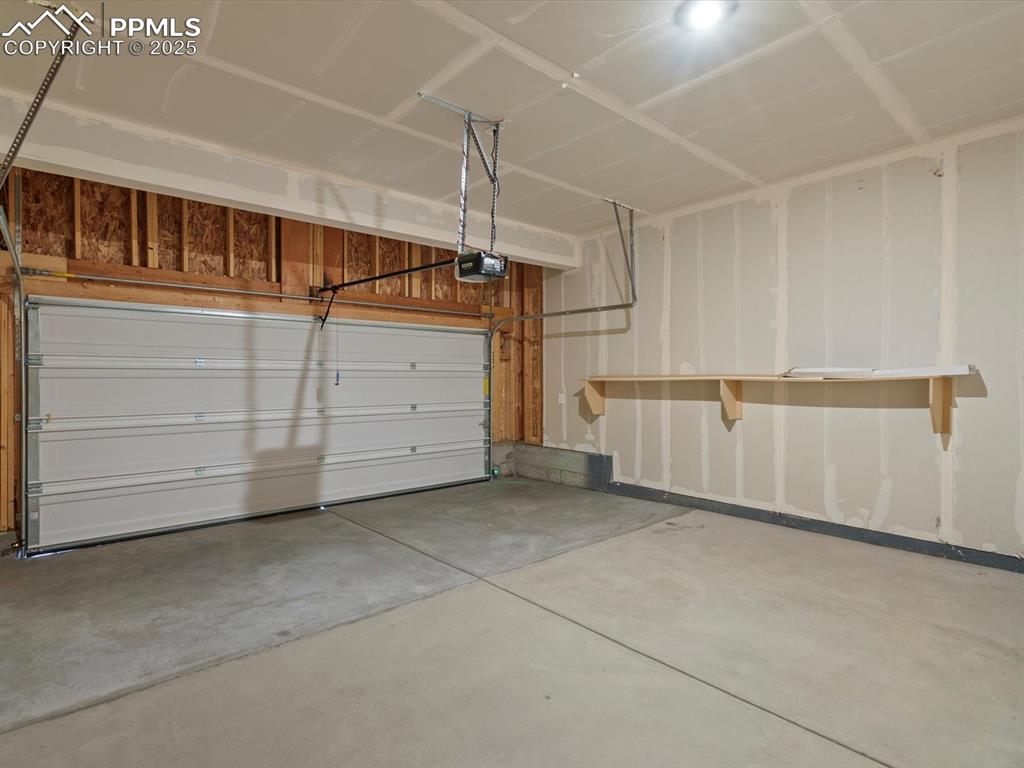 Image 9 of 25: Garage with a garage door opener