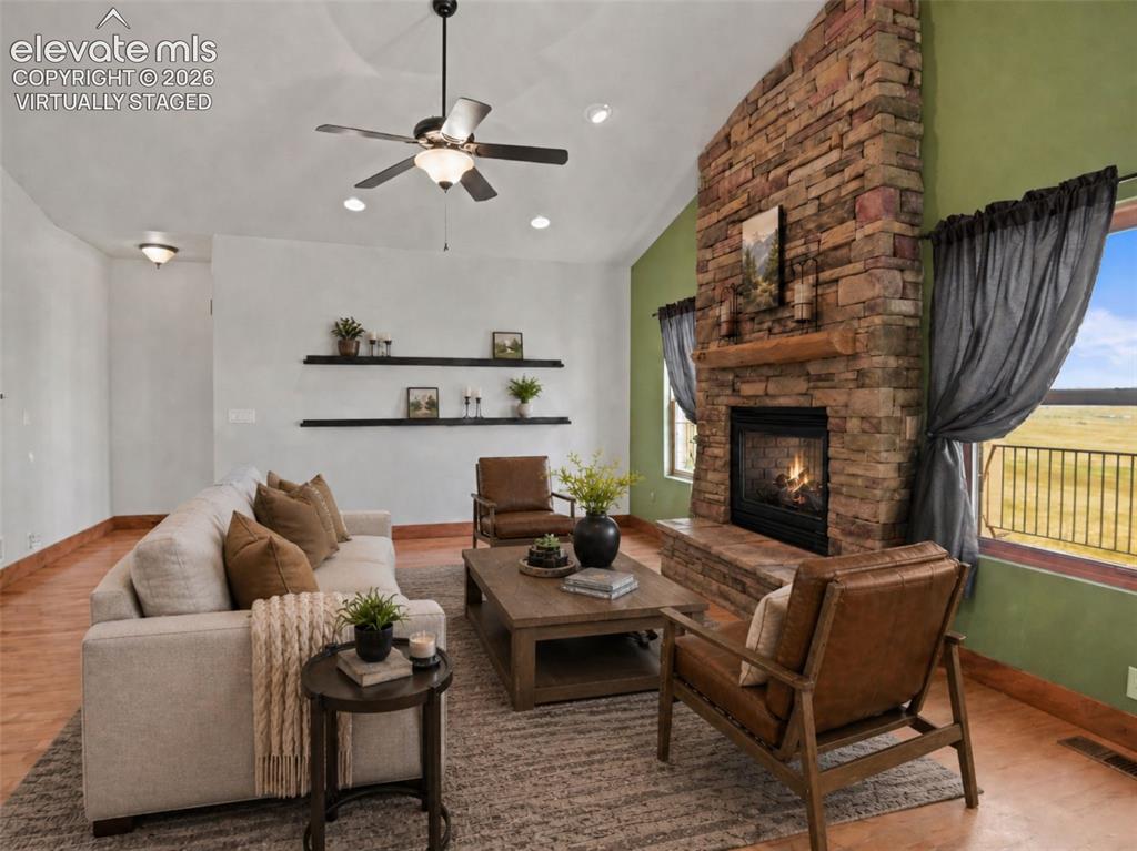 Image 13 of 50: living room with double sided fireplace. virtually staged