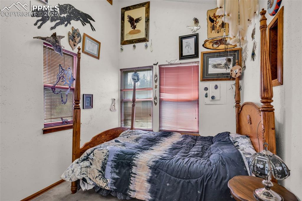 Image 18 of 33: Carpeted bedroom with baseboards and a textured wall