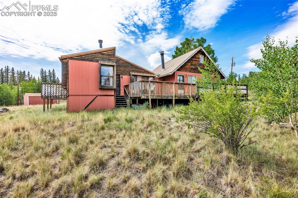 Image 24 of 33: Rear view of house featuring a wooden deck