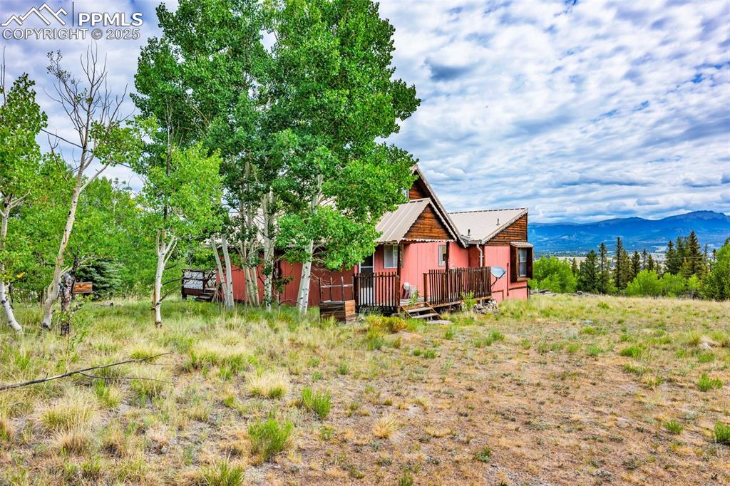 Image 27 of 33: View of yard featuring a deck with mountain view