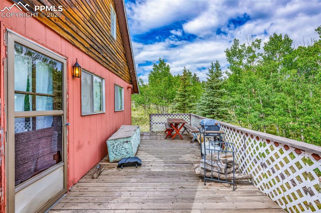Image 28 of 33: Deck featuring view of scattered trees