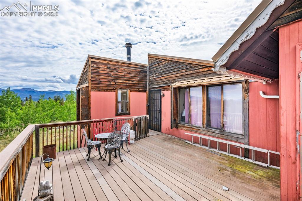 Image 29 of 33: Wooden deck with a mountain view