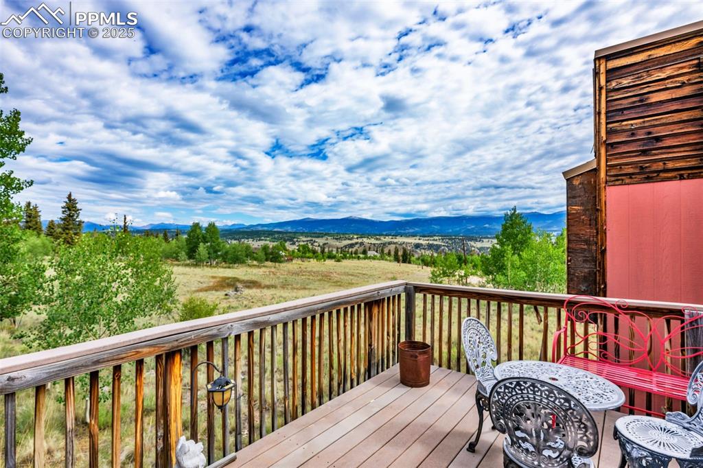 Image 30 of 33: Wooden deck with a mountain view