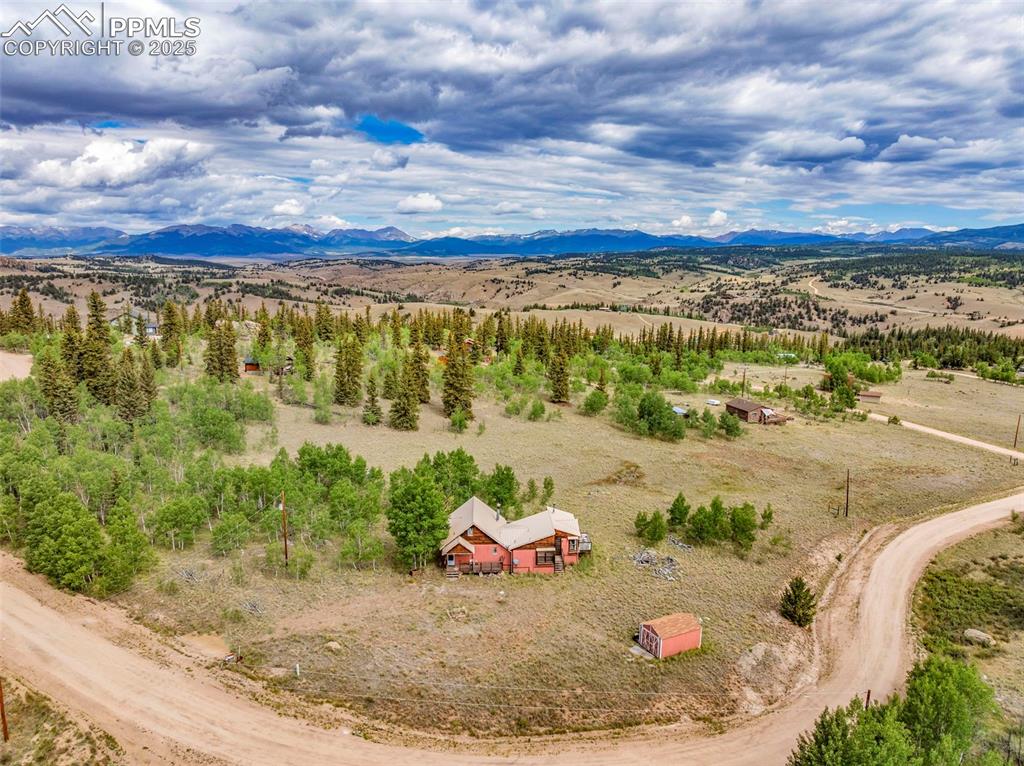 Image 32 of 33: Overview of rural landscape featuring a mountain backdrop