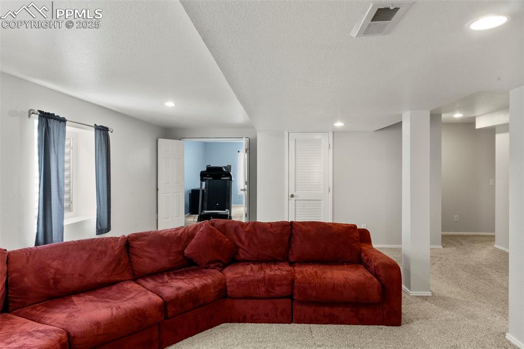 Image 29 of 38: Large living room, basement