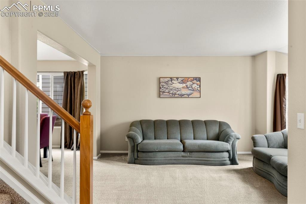 Image 7 of 38: sitting/living room near entry way door 