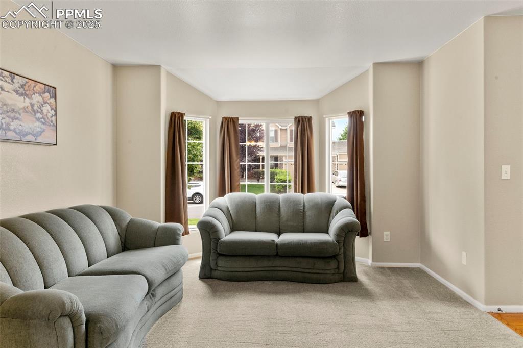 Image 8 of 38: sitting/living room showing bay windows 