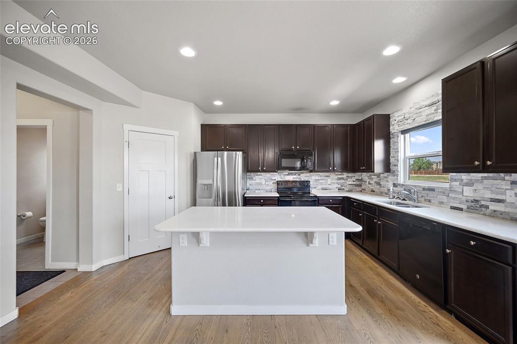 Image 11 of 48: Beautiful kitchen with island and huge pantry.