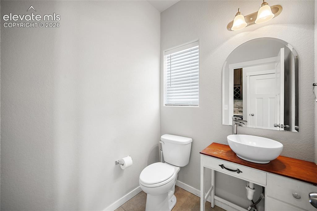 Image 14 of 48: Main level guest bathroom.