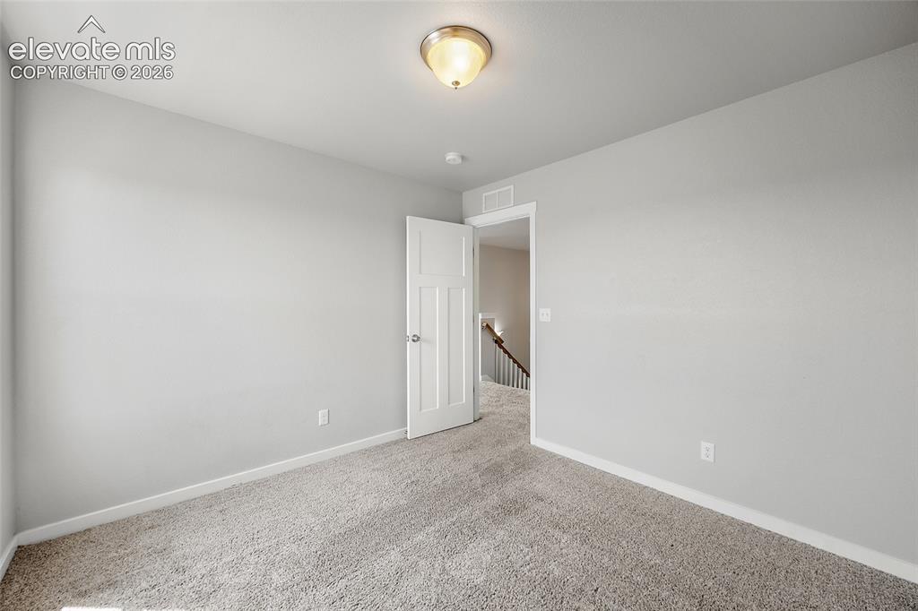 Image 19 of 48: Upper level bedroom #1.