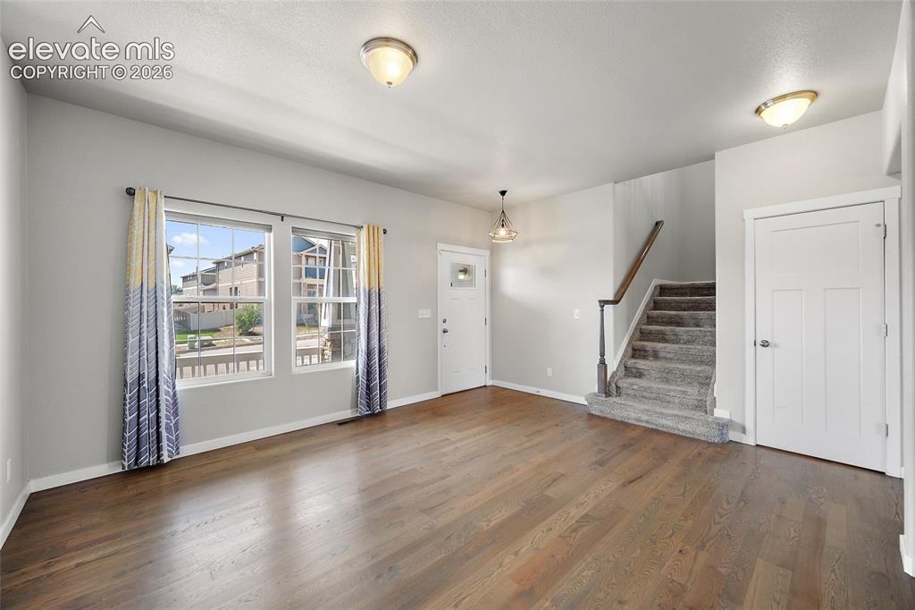 Image 2 of 48: Formal living room with hardwood floors.