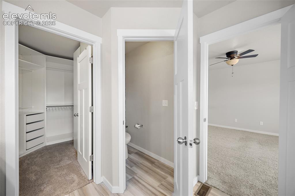Image 28 of 48: Walk-in closet with shelving system.