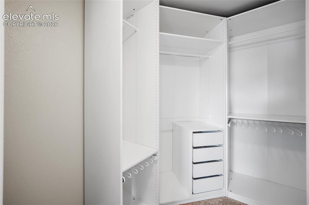 Image 29 of 48: Primary walk-in closet.