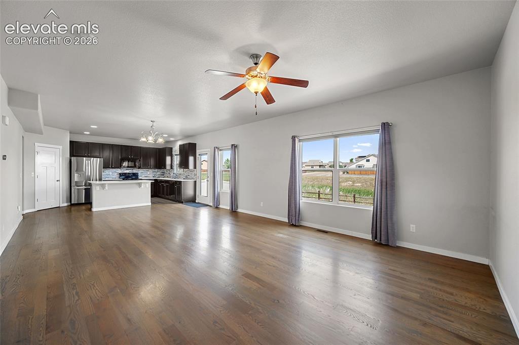 Image 7 of 48: Family room opens to the dining area and kitchen.