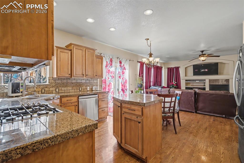 Image 16 of 49: Granite tile countertops and stainless steel appliances