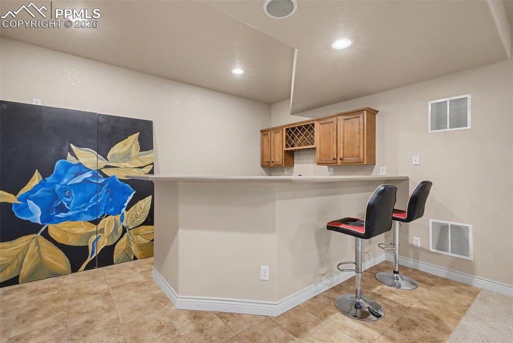 Image 38 of 49: Wet bar in Family Room/Rec room area 