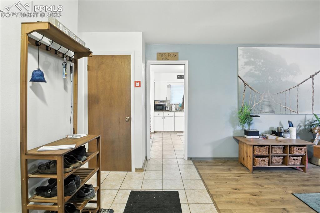Image 10 of 35: Hall featuring light tile patterned floors