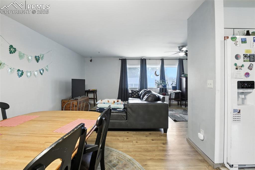 Image 12 of 35: Dining space with light wood-style floors and a ceiling fan