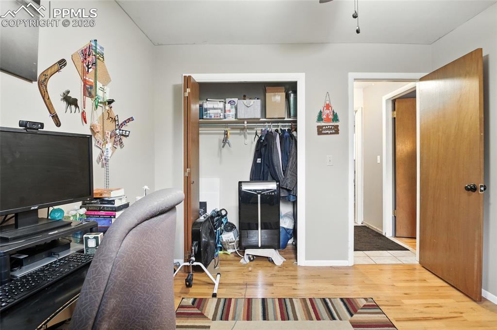 Image 16 of 35: Office space featuring light wood finished floors and ceiling fan