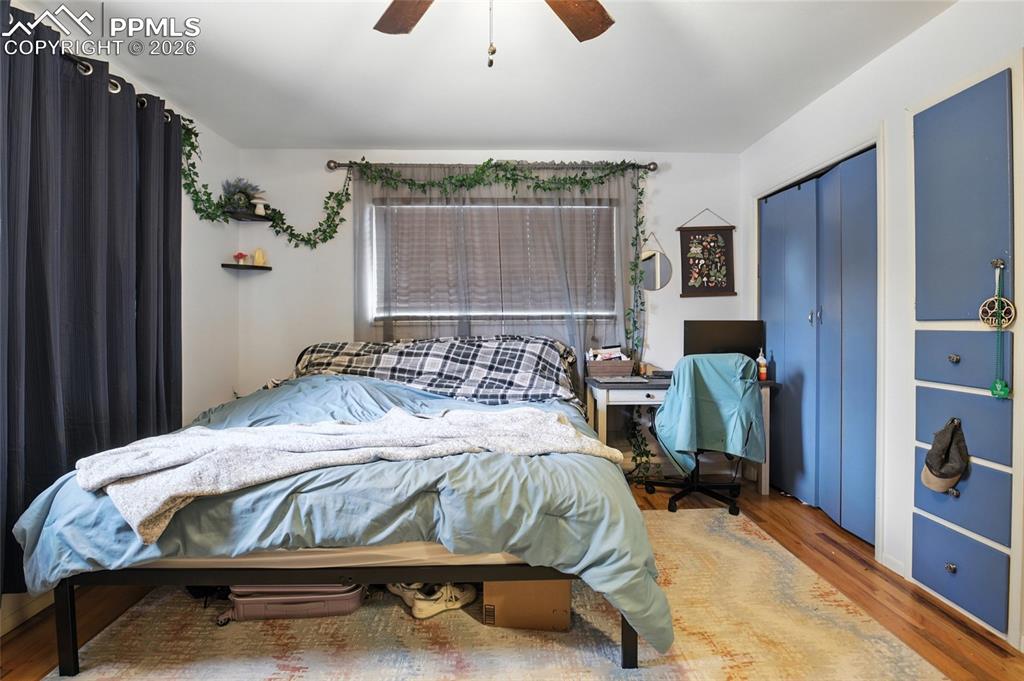 Image 17 of 35: Bedroom with wood finished floors, a closet, and ceiling fan