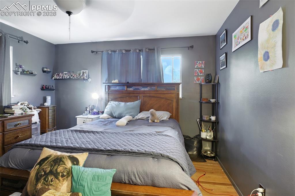 Image 20 of 35: Bedroom with wood finished floors and a ceiling fan
