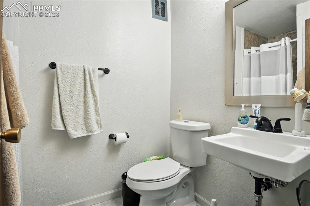 Image 29 of 35: Full bathroom featuring a textured wall