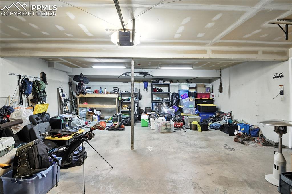 Image 30 of 35: Garage featuring a workshop area and a garage door opener