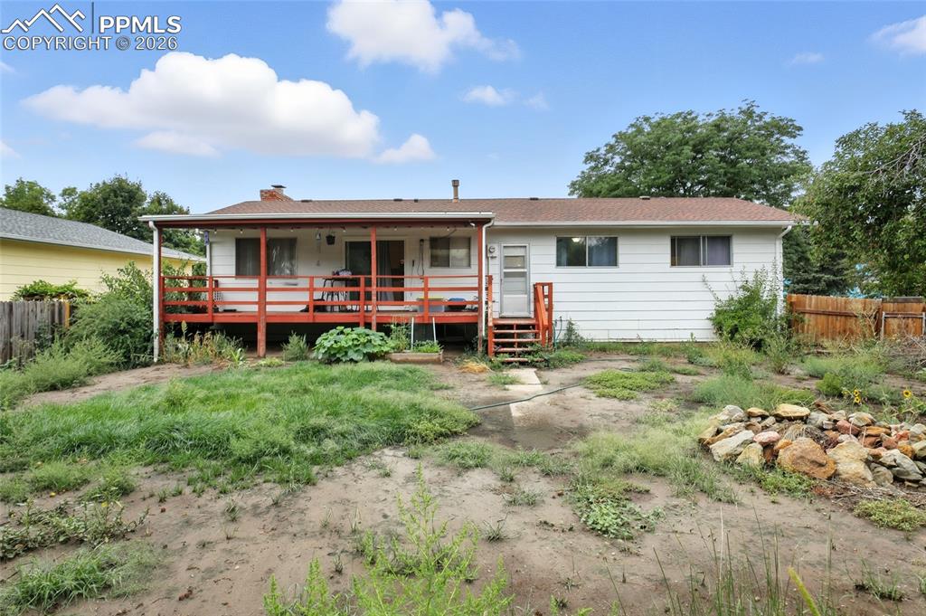 Image 33 of 35: Back of property featuring a chimney