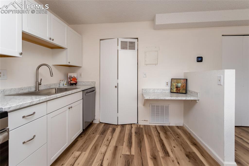 Image 10 of 27: Mechanical room and laundry area are located off the kitchen.