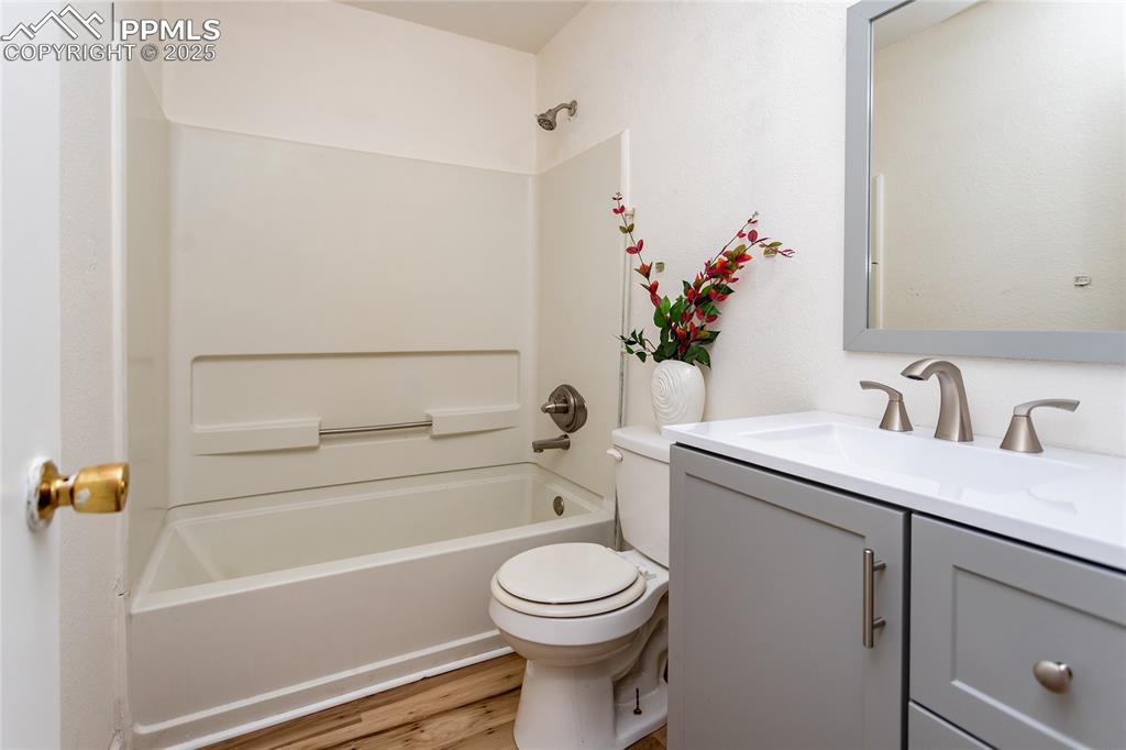 Image 15 of 27: Full bathroom has a new vanity with new plumbing and light fixtures.