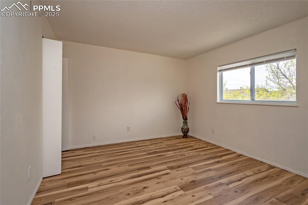 Image 17 of 27: Spacious Primary Bedroom with new wood laminate flooring!