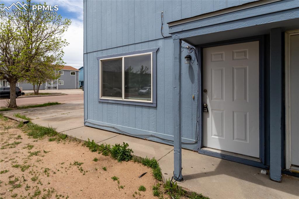 Image 2 of 27: Covered entry to the 2 story unit.