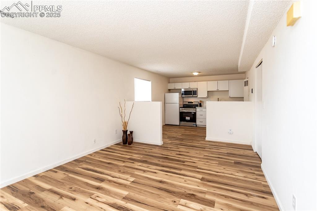 Image 3 of 27: Spacious Living Room opens up to the kitchen and the dining area.