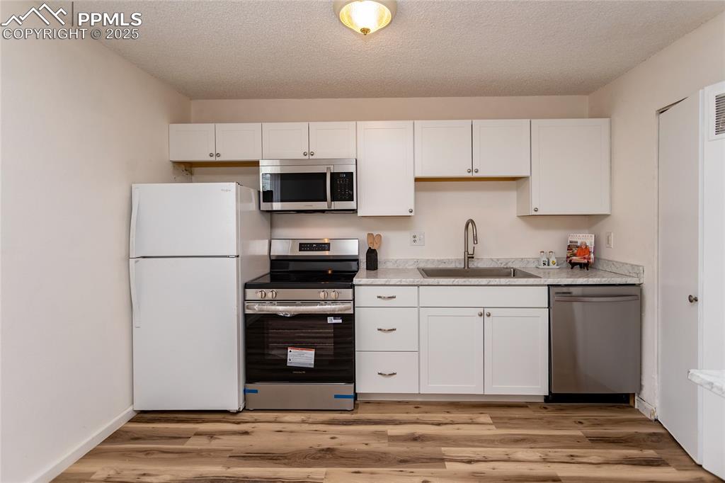 Image 8 of 27: Remodeled kitchen offers new cabinets, countertops and new stainless range/