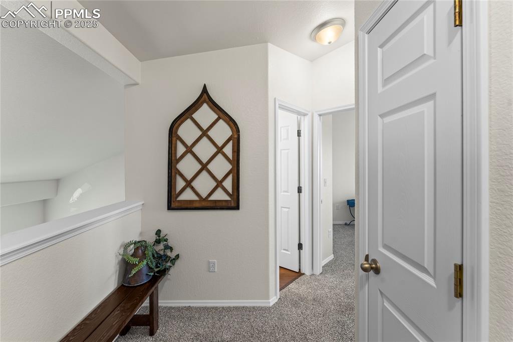 Image 16 of 22: Upper landing area with open view to lower level.