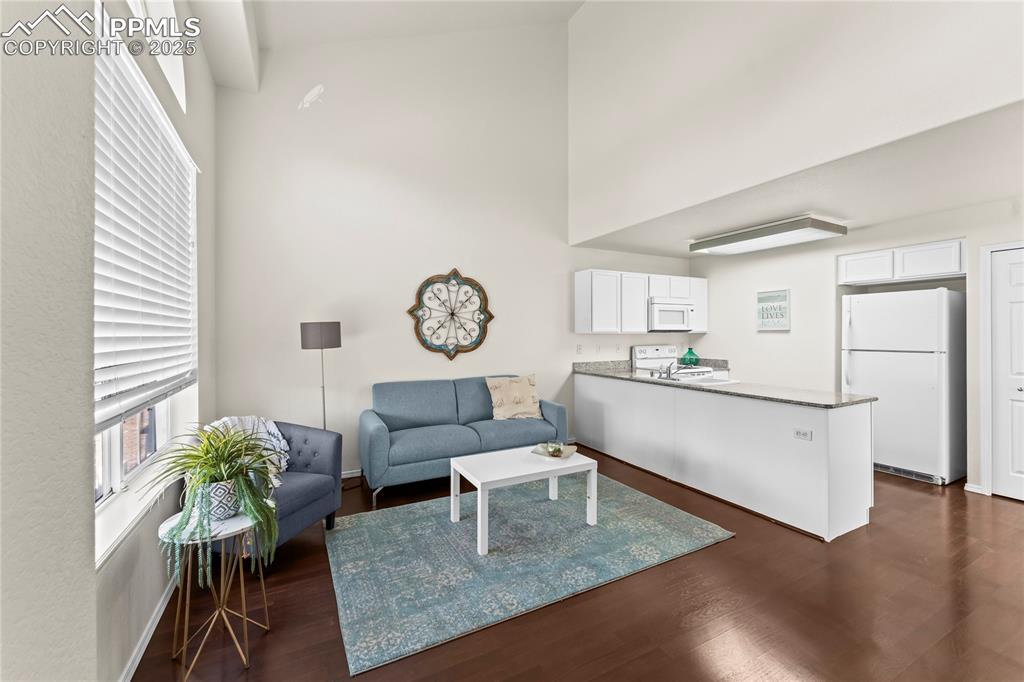 Image 2 of 22: Entry into living room plenty of natural light and  open floorplan.