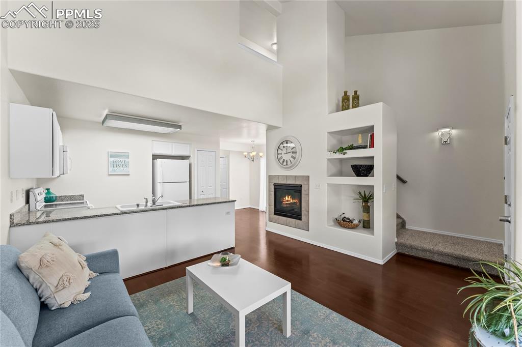 Image 3 of 22: Entryway to stairs or onto main level living room. Beautiful fireplace.