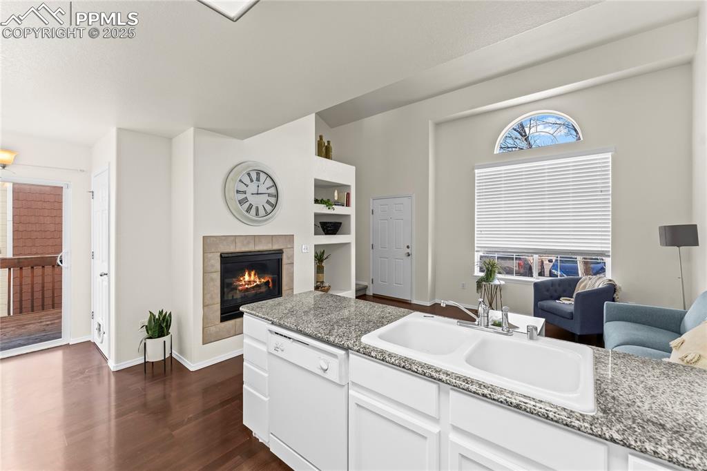 Image 7 of 22: Beautiful countertops, and white kitchen cabinets and appliances, with walk